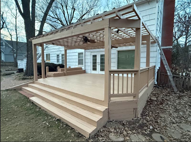 Professionally restored wooden deck and pergola in Kansas City featuring clean structural wood restoration and fresh protective sealant.