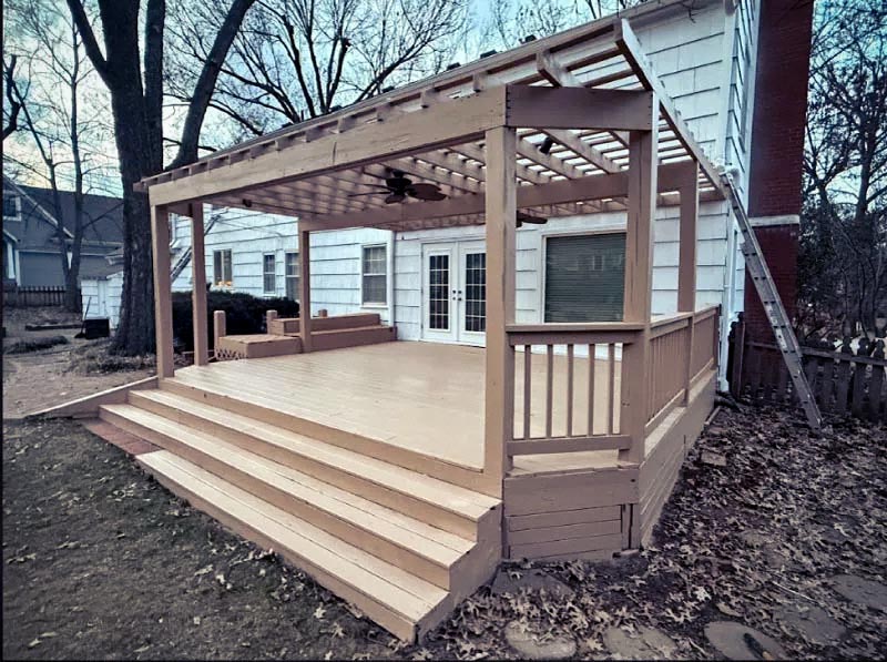 Professionally restored wooden deck and pergola in Kansas City featuring clean structural wood restoration and fresh protective sealant.
